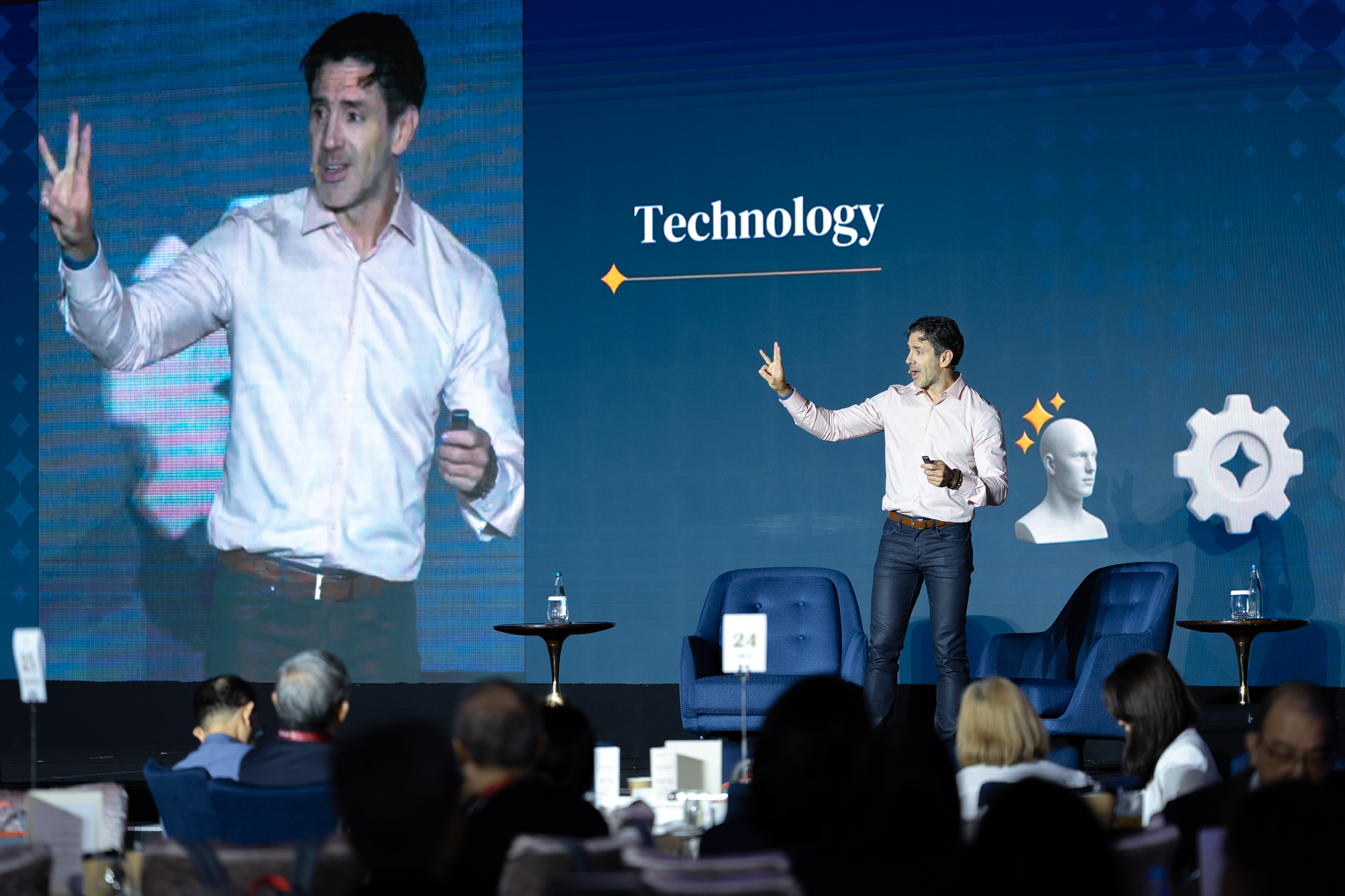 Oseas on stage at MAP Philippines — speaking on technology and AI